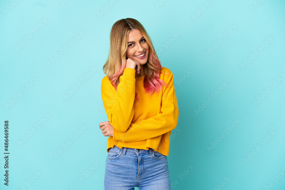 Young woman over isolated blue background laughing Young woman over isolated blue background laughing