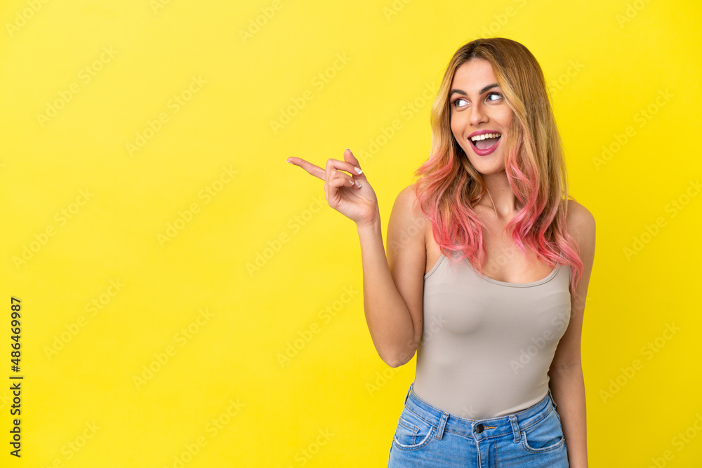 Young woman over isolated yellow background intending to realizes the solution while lifting a finger up Young woman over isolated yellow background intending to realizes the solution while lifting a finger up
