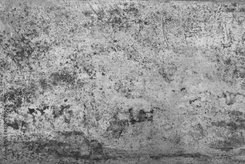 Old grunge dirty textured cement wall surface. With uneven stains and tiny holes.