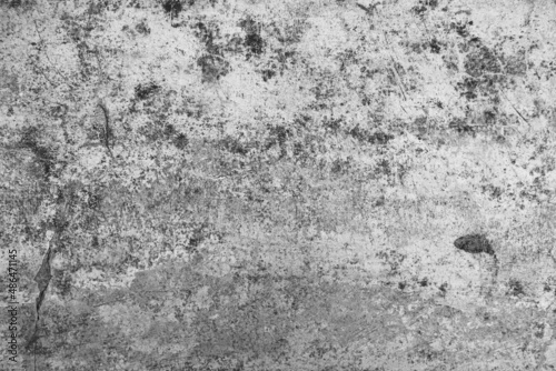 Old grunge dirty textured cement wall surface. With uneven stains and tiny holes.