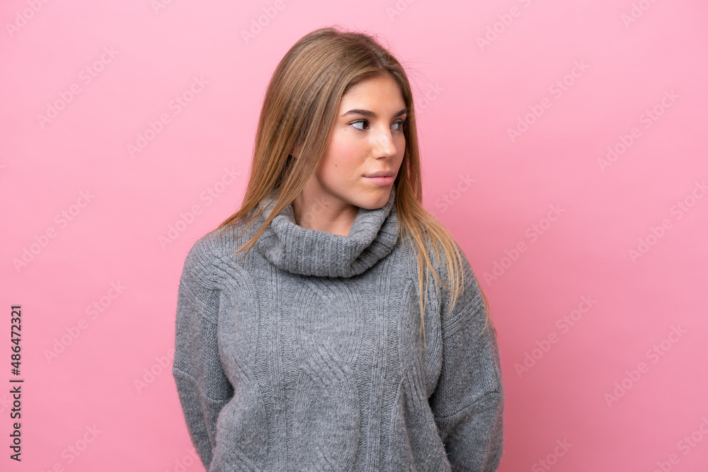 Young caucasian woman isolated on pink bakcground looking to the side Young caucasian woman isolated on pink bakcground looking to the side