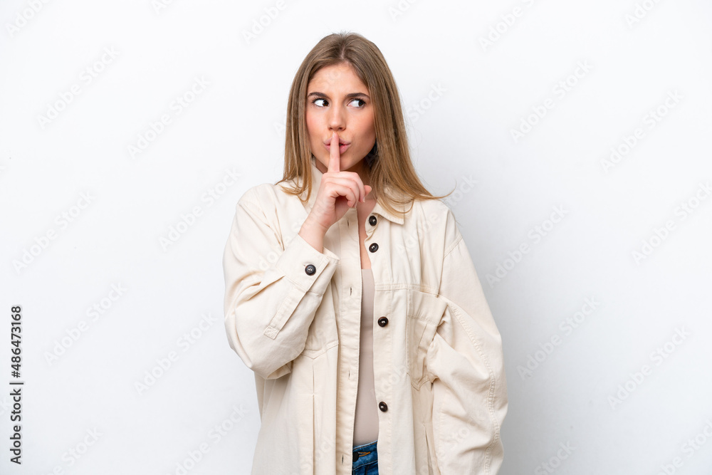 Young caucasian woman isolated on white bakcground showing a sign of silence gesture putting finger in mouth Young caucasian woman isolated on white bakcground showing a sign of silence gesture putting finger in mouth