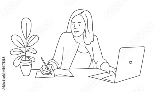 Business woman working on laptop at her desk.