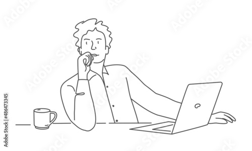 Thoughtful man working on laptop at workplace.