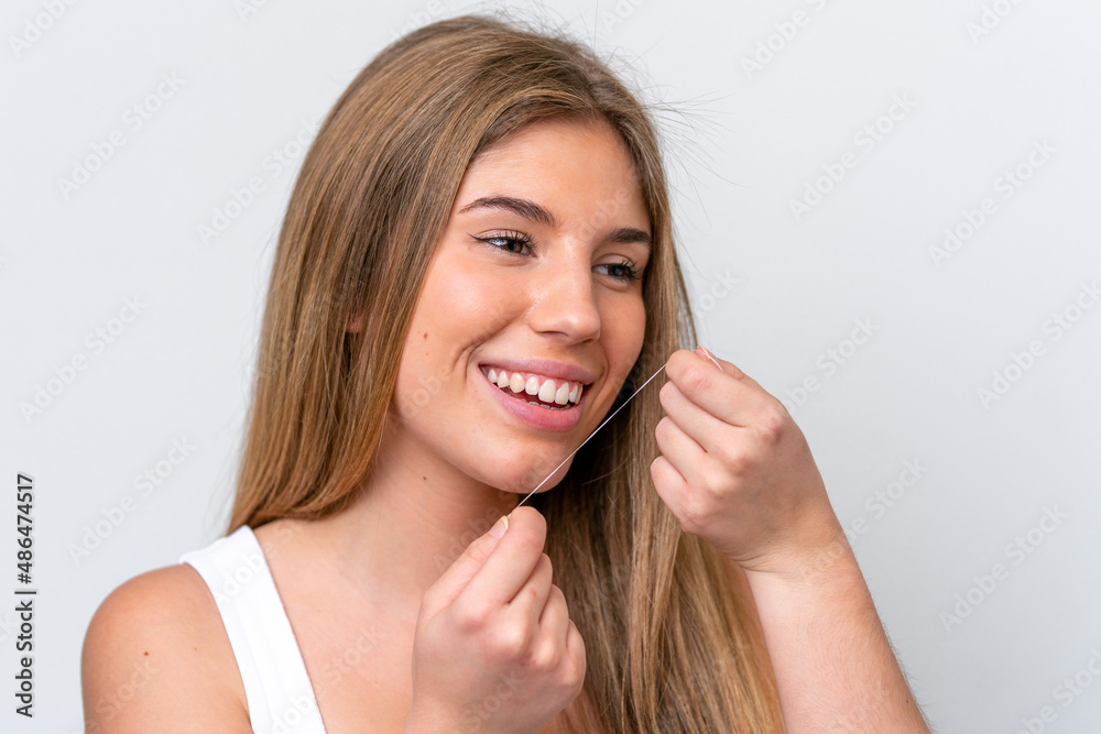 Young caucasian woman isolated on white background with dental floss. Close up portrait Young caucasian woman isolated on white background with dental floss. Close up portrait