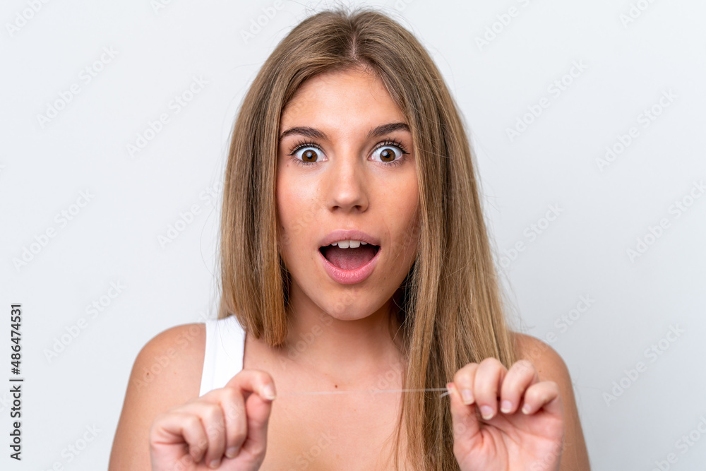Young caucasian woman isolated on white background with dental floss. Close up portrait Young caucasian woman isolated on white background with dental floss. Close up portrait