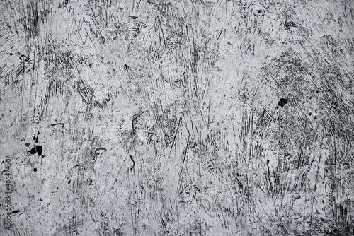 Old grunge dirty textured cement wall surface. With uneven stains and tiny holes.