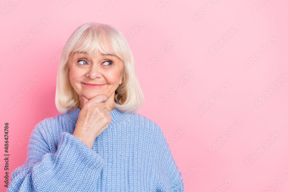 Photo of pretty senior woman hand touch chin look empty space think wonder isolated over pink color background Photo of pretty senior woman hand touch chin look empty space think wonder isolated over pink color background