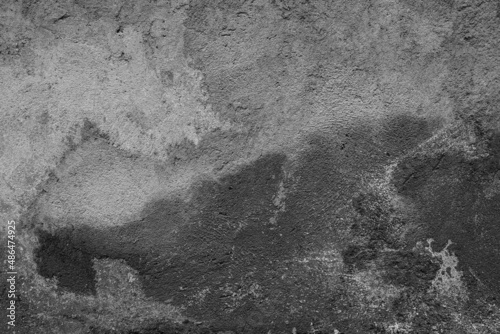 Old grunge dirty textured cement wall surface. With uneven stains and tiny holes.