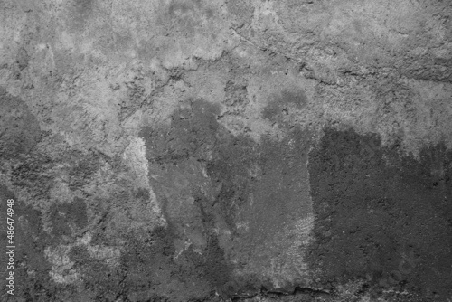 Old grunge dirty textured cement wall surface. With uneven stains and tiny holes.