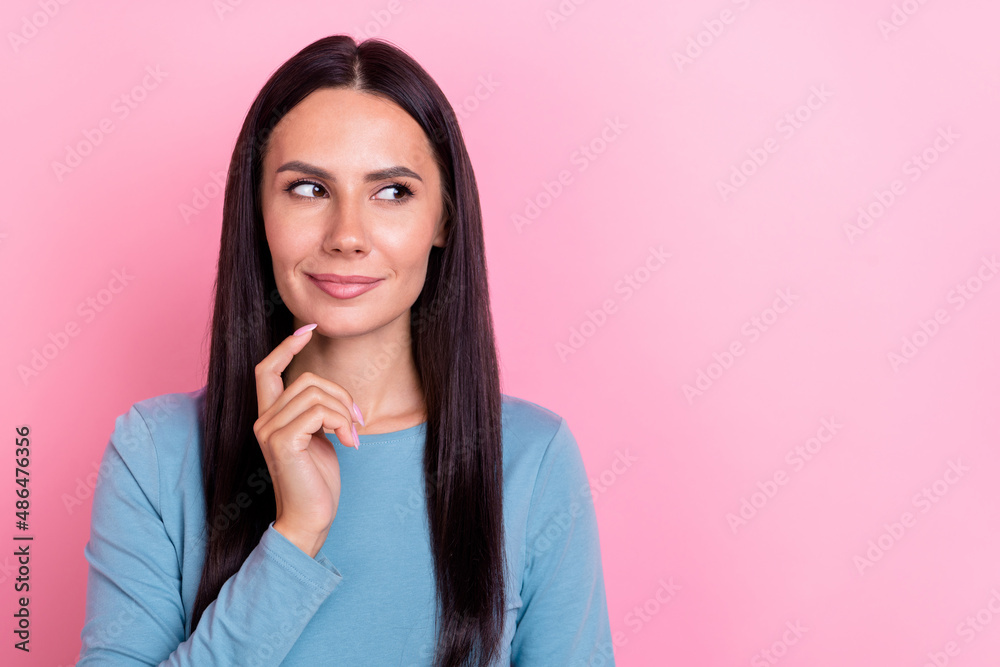 Photo of pretty thoughtful young woman wear blue shirt finger chin looking empty space isolated pink color background Photo of pretty thoughtful young woman wear blue shirt finger chin looking empty space isolated pink color background