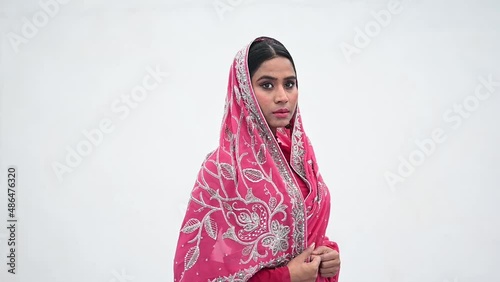Serious Indian woman with covered hear wearing a saree photo