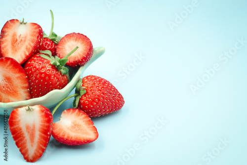 Top view of red strawberry on pastel background with copy space.