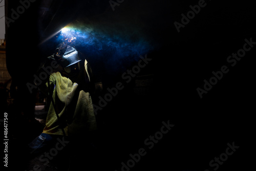 Fototapeta Naklejka Na Ścianę i Meble -  Welder welding a ship at a shipyard