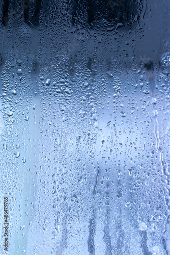 Condensation on the clear glass window. Water drops. Rain. Abstract background texture. Outside the window, bad weather, rain