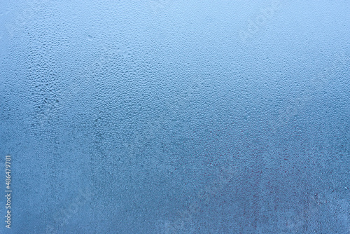 Water droplets condensation background of dew on glass, humidity and foggy blank background. Condensation on the glass of metal-plastic window. Outside the window, bad weather, rain photo