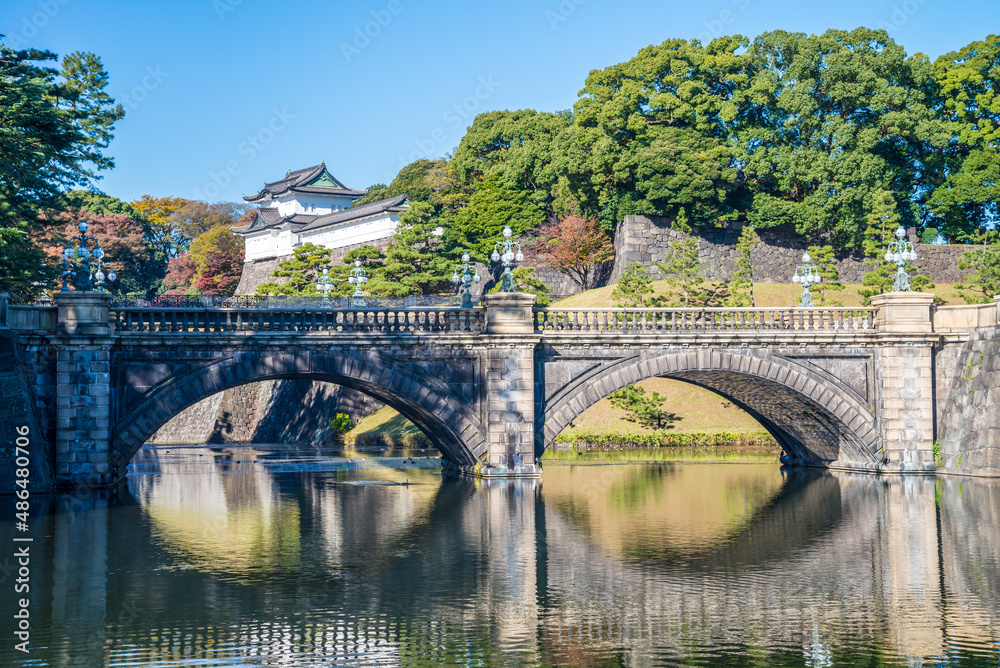 Beautiful the Tokyo Imperial Palace with eye glasses stone bridge reflection in blue sky sunny day, Tokyo Japan. The primary residence of the Emperor of Japan. Famous destination traveling in Asia.