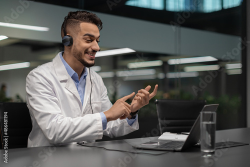 Handsome young middle eastern scientist using laptop at office