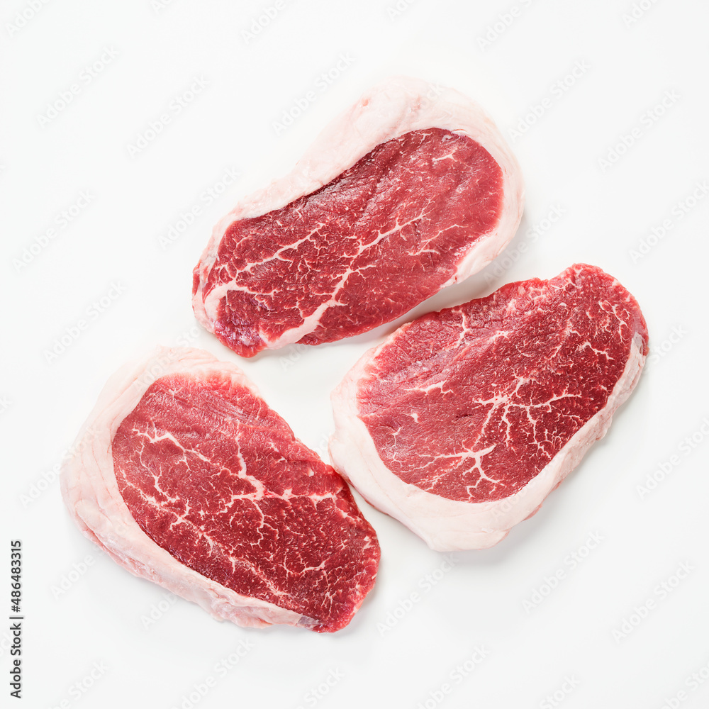 Raw Steak Ribeye Black Angus on white background. Top view.