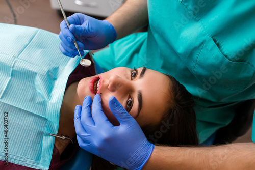 Portrait of a scared woman during dental examination.