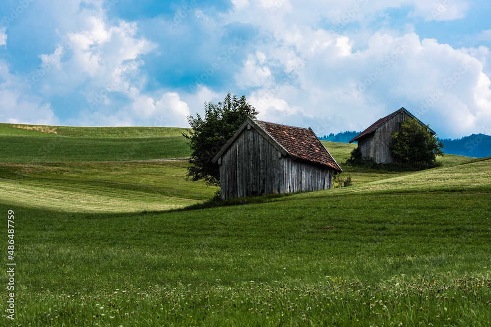 Scenic view over the German countryside around the village Kappel with two old wooden sheds over the green hills Scenic view over the German countryside around the village Kappel with two old wooden sheds over the green hills