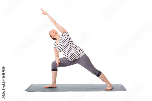 Pregnancy yoga exercise - pregnant woman doing asana Utthita Parsvakonasana - Extended Side Angle Pose isolated on white background photo