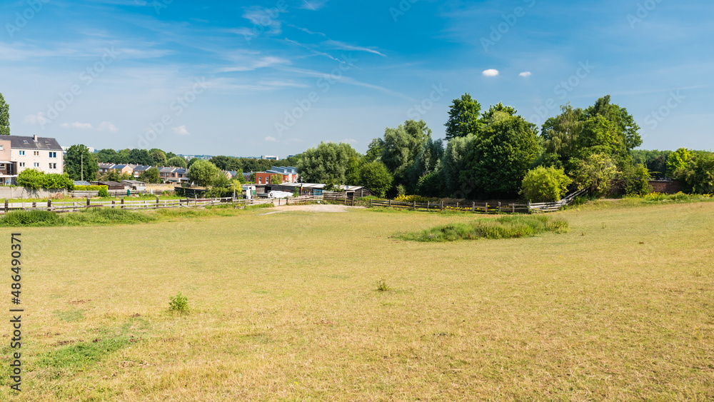  Molenbeek, Brussels / Belgium - 07 20 2018: Scenic view over dry grass meadows in the city suburbs in summer
