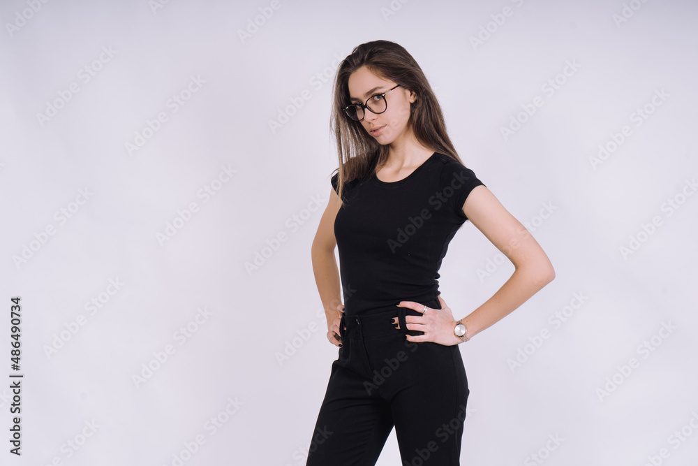 Young Female model in studio. high fashion portrait of young elegant woman. skinny black pants, black heels shoes. Young Female model in studio. high fashion portrait of young elegant woman. skinny black pants, black heels shoes.
