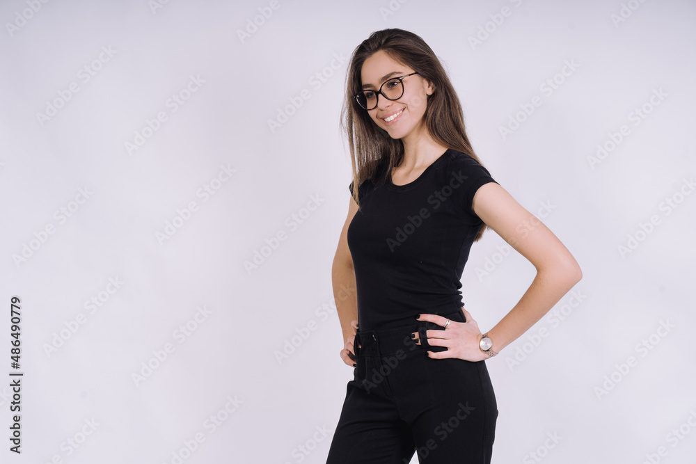 Young Female model in studio. high fashion portrait of young elegant woman. skinny black pants, black heels shoes. Young Female model in studio. high fashion portrait of young elegant woman. skinny black pants, black heels shoes.