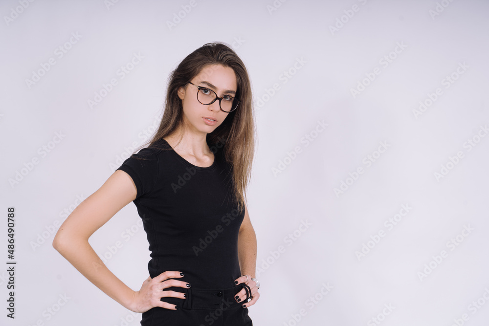 Young Female model in studio. high fashion portrait of young elegant woman. skinny black pants, black heels shoes. Young Female model in studio. high fashion portrait of young elegant woman. skinny black pants, black heels shoes.