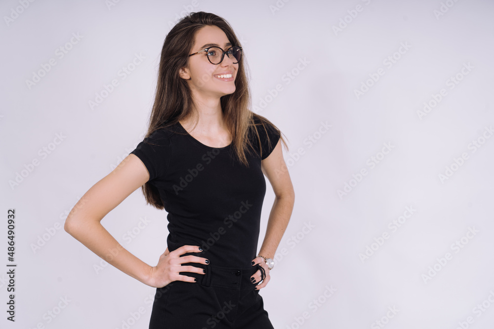 Young Female model in studio. high fashion portrait of young elegant woman. skinny black pants, black heels shoes. Young Female model in studio. high fashion portrait of young elegant woman. skinny black pants, black heels shoes.