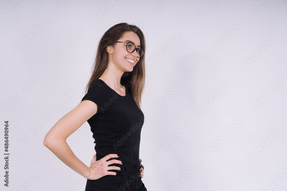 Young Female model in studio. high fashion portrait of young elegant woman. skinny black pants, black heels shoes. Young Female model in studio. high fashion portrait of young elegant woman. skinny black pants, black heels shoes.