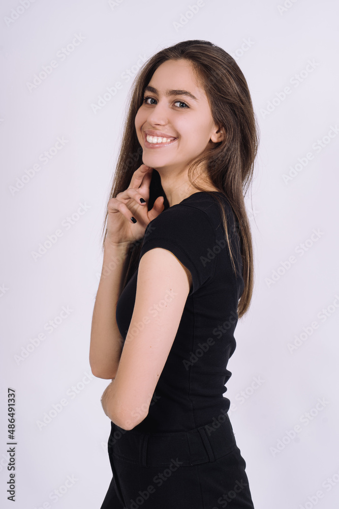 Young Female model in studio. high fashion portrait of young elegant woman. skinny black pants, black heels shoes. Young Female model in studio. high fashion portrait of young elegant woman. skinny black pants, black heels shoes.