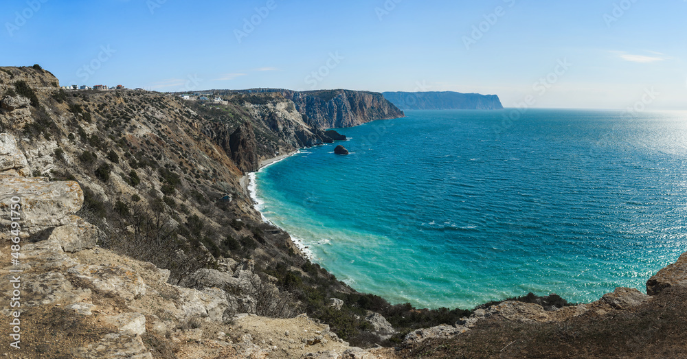 Panorama of Crimean rugged rocky shore with Saint George Monastery and rock of Holy Apparition in spring. View from Cape Fiolent. Sevastopol, Crimea