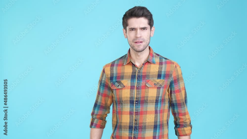 Grumpy moody guy cross arms have disagreement isolated blue color background Grumpy moody guy cross arms have disagreement isolated blue color background