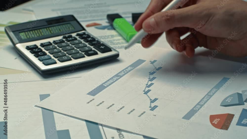 Businessman working on finances at home office. Accountant is using calculator and checking figures. Entrepreneur is analysing a monthly budget. Businessman working on finances at home office. Accountant is using calculator and checking figures. Entrepreneur is analysing a monthly budget.