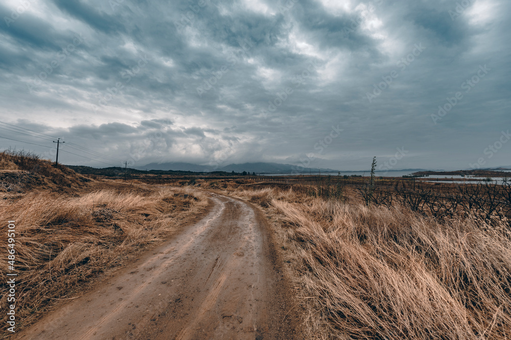 Obraz premium Photo of picturesque mountain area, road, blue cloudy sky