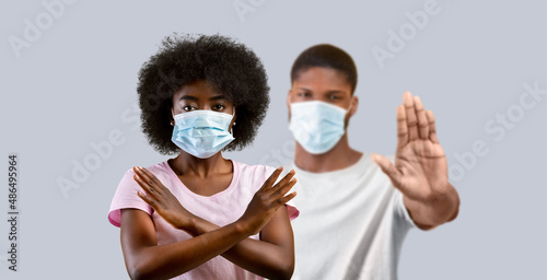 Young african american people wearing medical masks gesturing