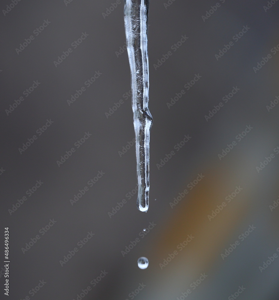 A drop of water detached from an icicle falls down A drop of water detached from an icicle falls down