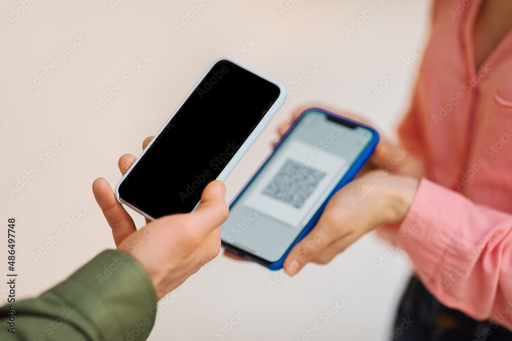 Unrecognizable Man Using Smartphone Scanning QR Code On Lady's Phone Unrecognizable Man Using Smartphone Scanning QR Code On Lady's Phone