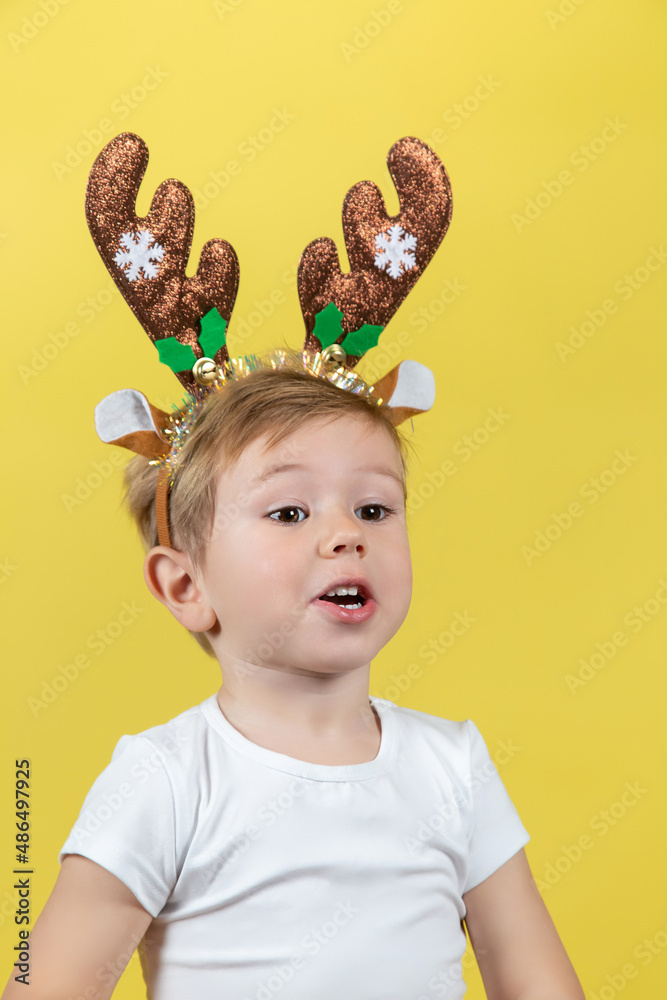 Cute boy in in christmas reindeer costume making funny faces Cute boy in in christmas reindeer costume making funny faces