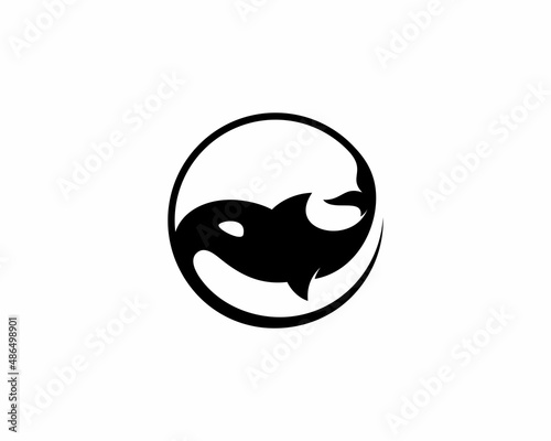 Whale silhouette in yin and yang shape logo