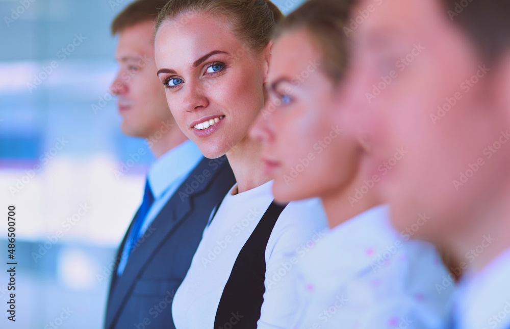 Smiling successful business team standing in office Smiling successful business team standing in office