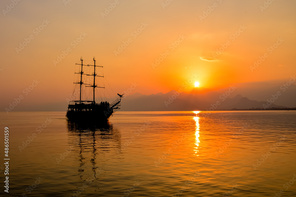 Antalya / Turkey  December 14, 2019: Beautiful view  Sailing boats silhouetted by sunset light in harbor of Antalya Kaleiçi Old town (Kaleici) in Antalya, Turkey