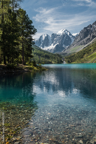 Wallpaper Mural The shore of a clear mountain lake with clear blue water and a rocky bottom Torontodigital.ca