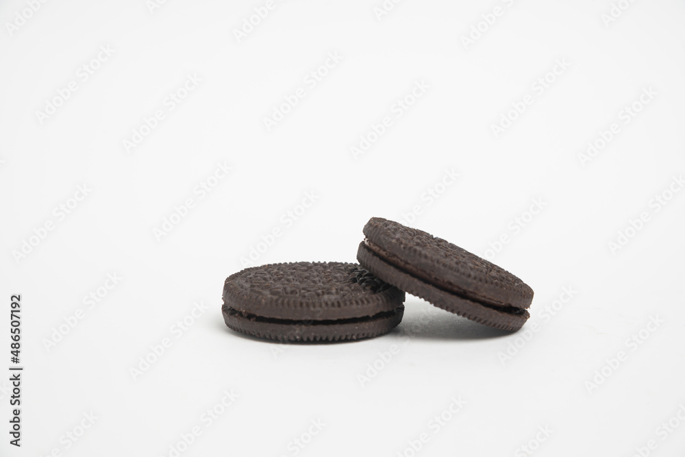 Fototapeta premium Chocolate cookies with cream filling isolated on white background.