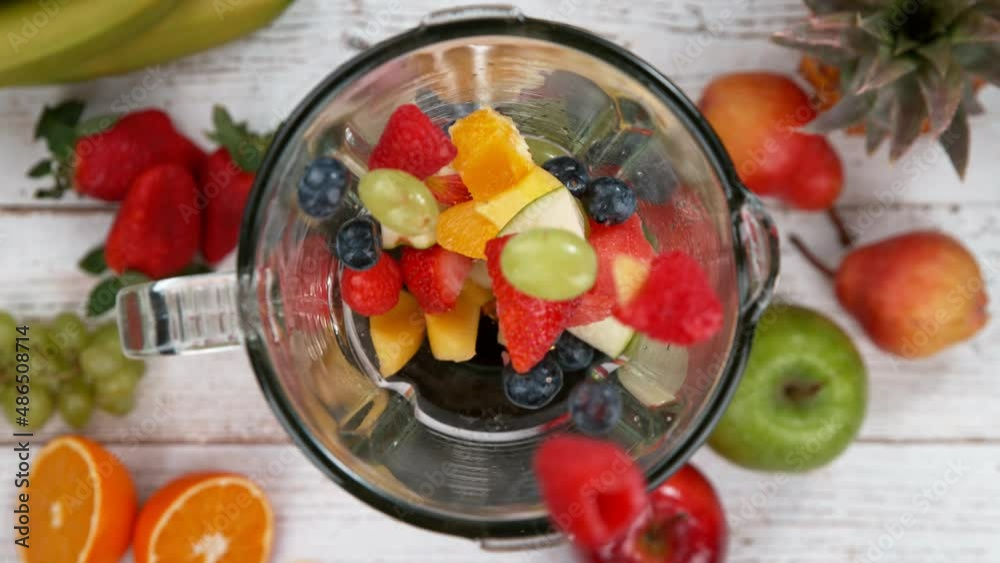 Fresh fruit and vegetables smoothie blended in blender, top view. Healthy eating concept. Super slow motion filmed on high speed cinematic camera.