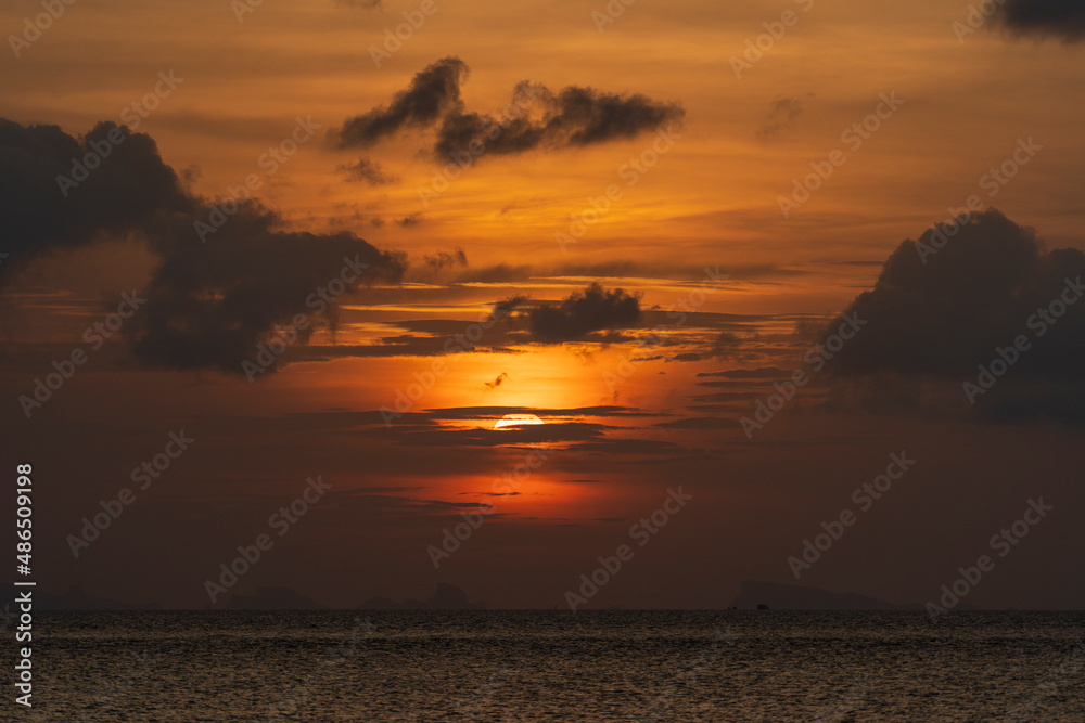 Beautiful sunset over the sea water on the island of Koh Phangan, Thailand. Travel and nature concept Beautiful sunset over the sea water on the island of Koh Phangan, Thailand. Travel and nature concept