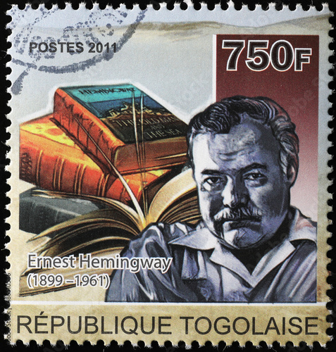 Ernest Hemingway and his books on postage stamp photo