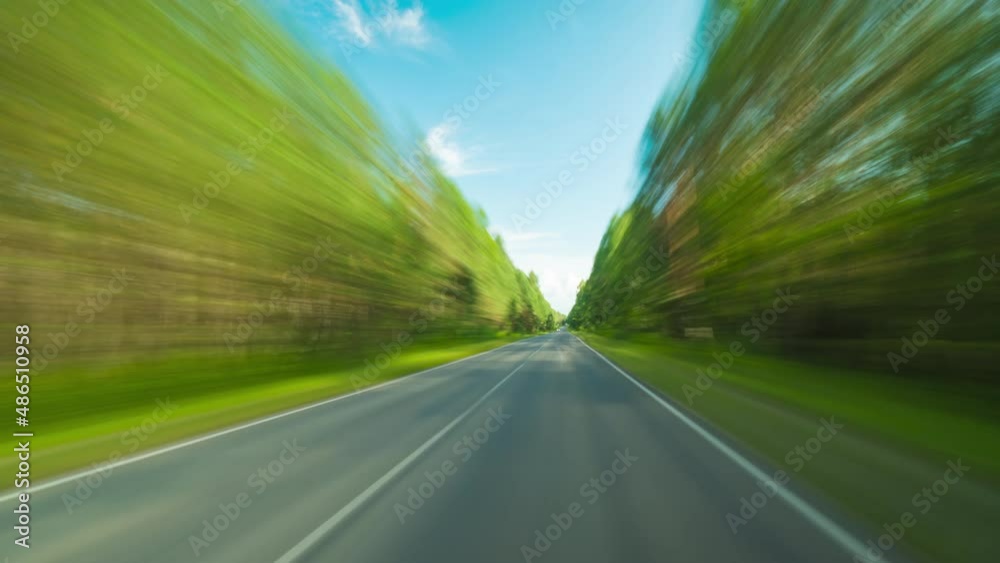4K Point of View Hyperlapse Time-lapse of Car Driving Through Country Road. Trees Stretch on Both Sides High Speed On The Open Road Fast Car Hyperlapse. Travel Concept Sort of Dashcam POV